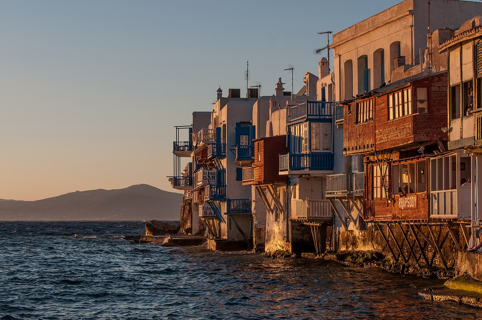 Sunset over the whitewashed windmills and Aegean Sea at Mykonos, Greece